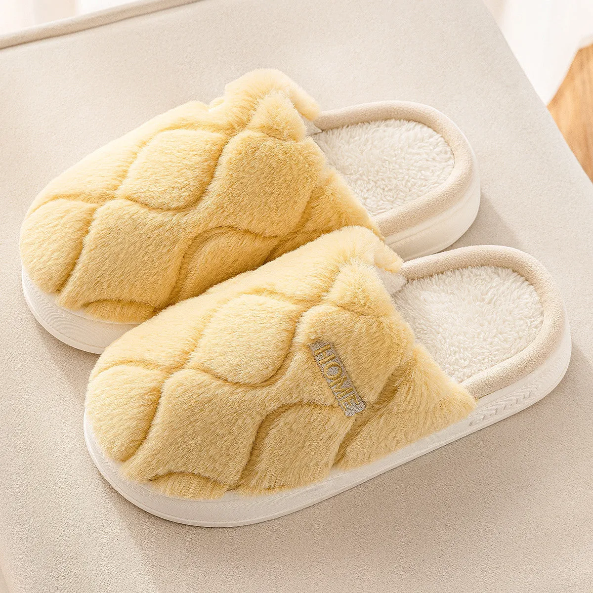 Plush indoor slippers in light gray with car stitching detail on the upper and PVC sole