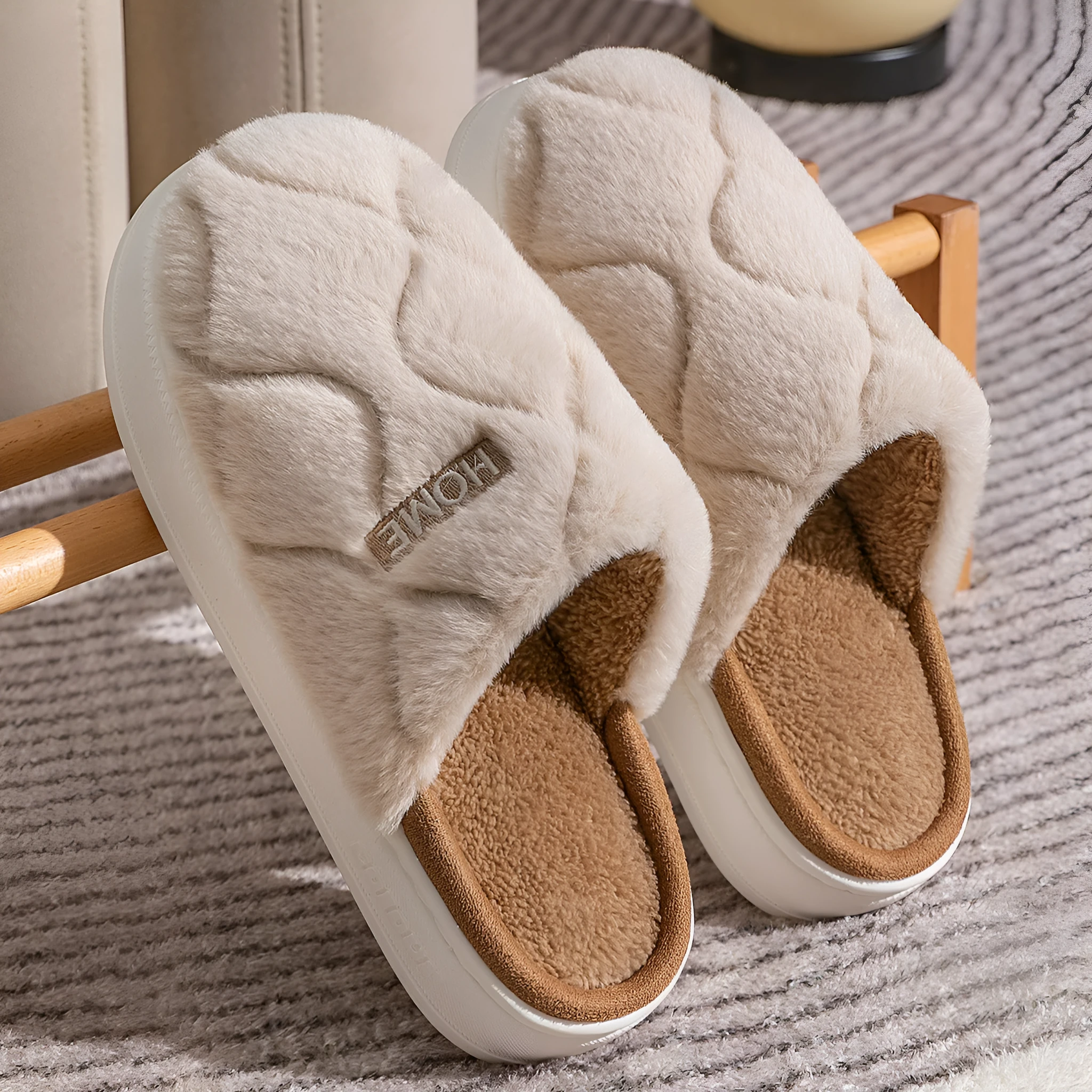 Plush indoor slippers in light gray with car stitching detail on the upper and PVC sole