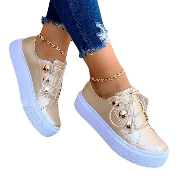 Women's lace-up rivet flats sneakers in white with round toe and front tie closure on polyurethane sole