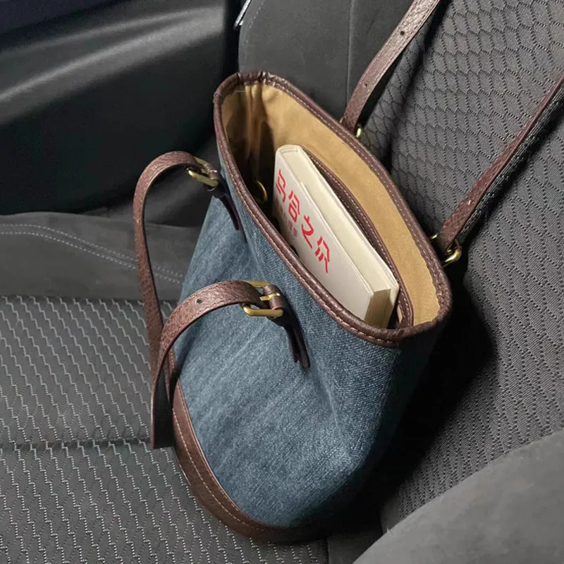 Denim patchwork handbag with retro bucket design showing dimensions and one-shoulder strap