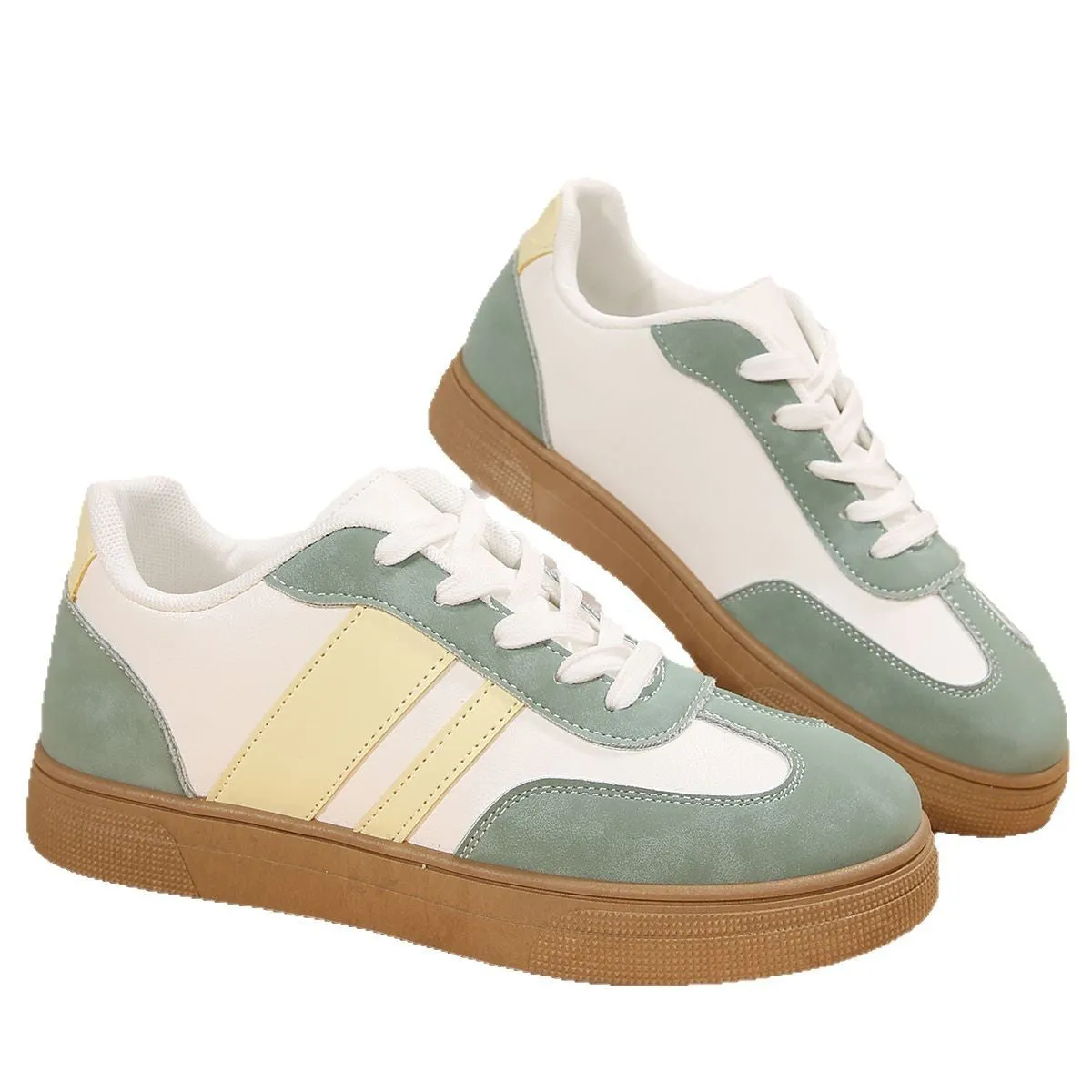 Green women's low-top retro sports shoes with cross straps and a flat rubber sole.