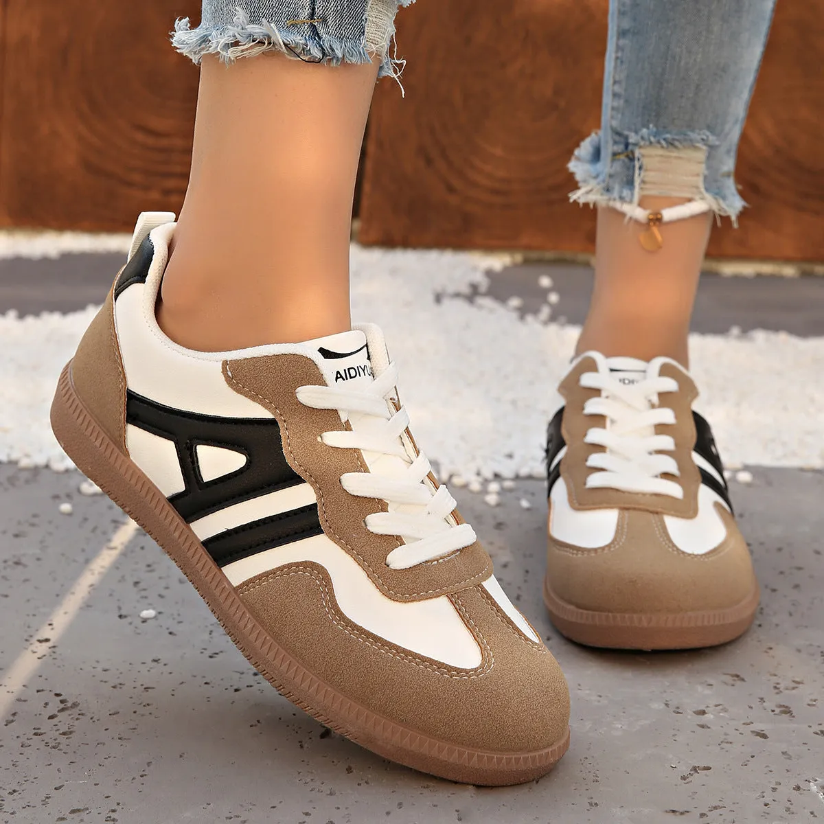 Women's retro colour matching lace-up jogging shoes in black, showing low-top design and platform heel.