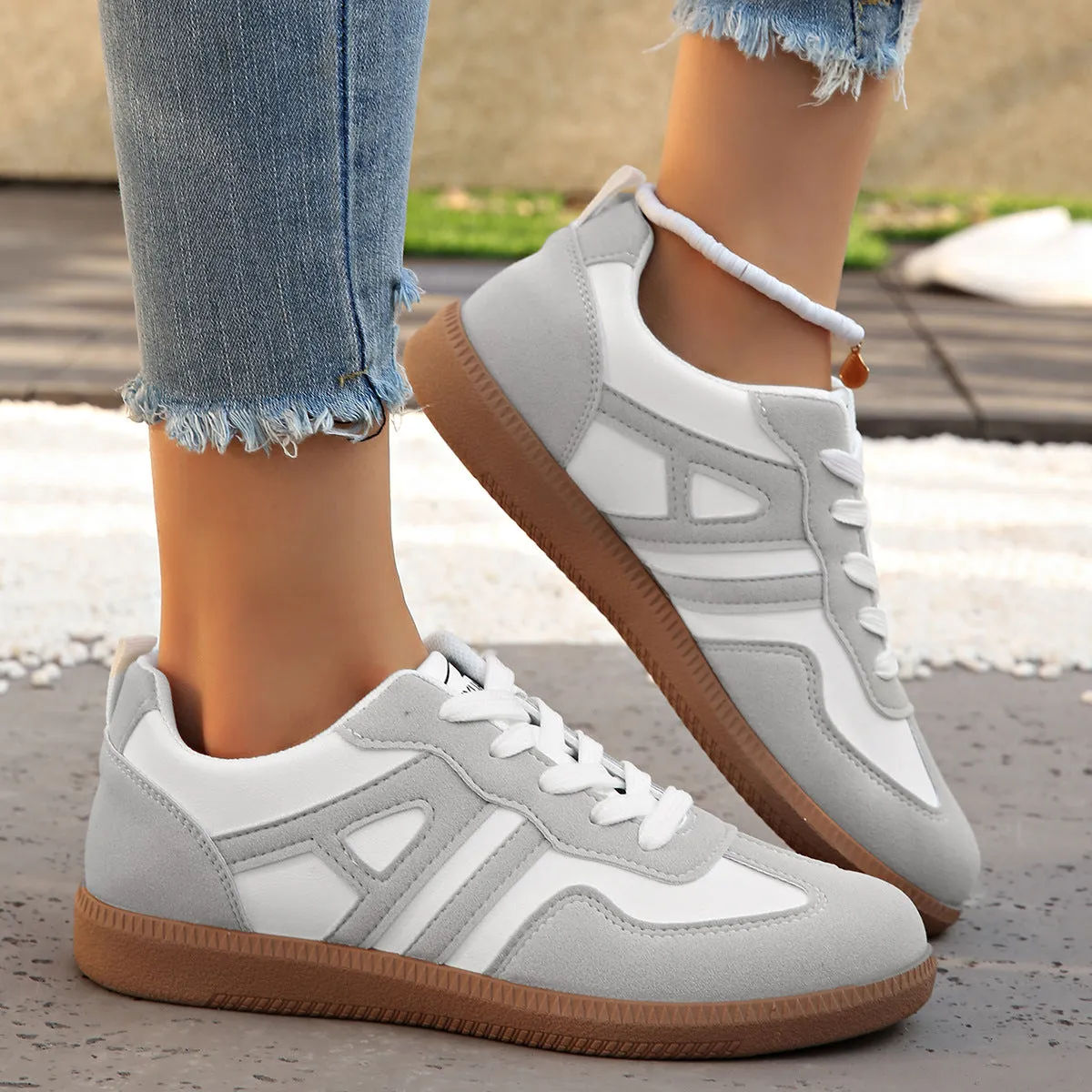 Women's retro colour matching lace-up jogging shoes in black, showing low-top design and platform heel.