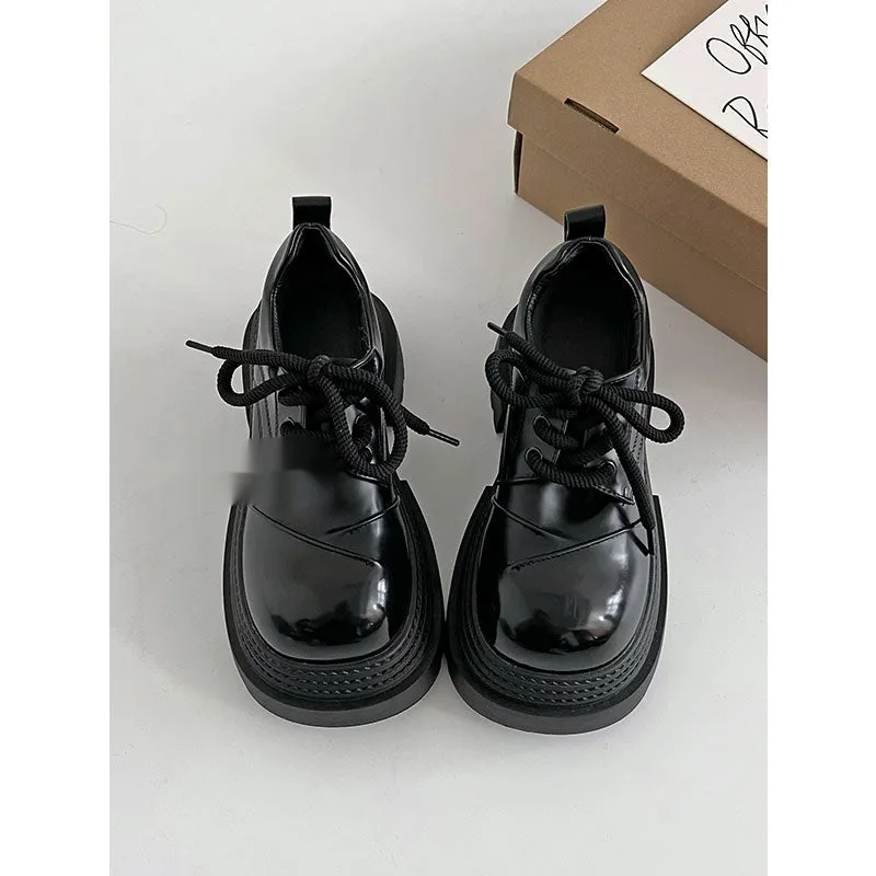 Retro British style loafers in solid colour with round toe and low muffin heel on a plain background