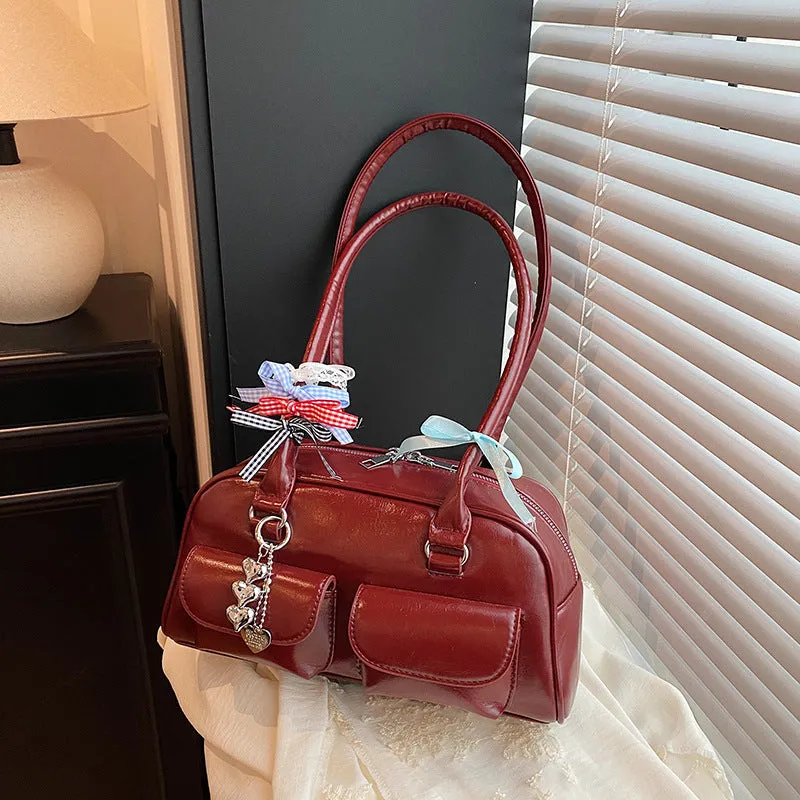 Retro brown PU leather pillow-shaped women's handbag with double straps and a flap closure.