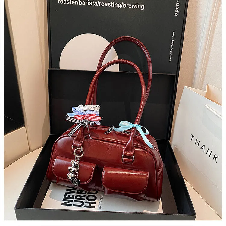 Retro brown PU leather pillow-shaped women's handbag with double straps and a flap closure.