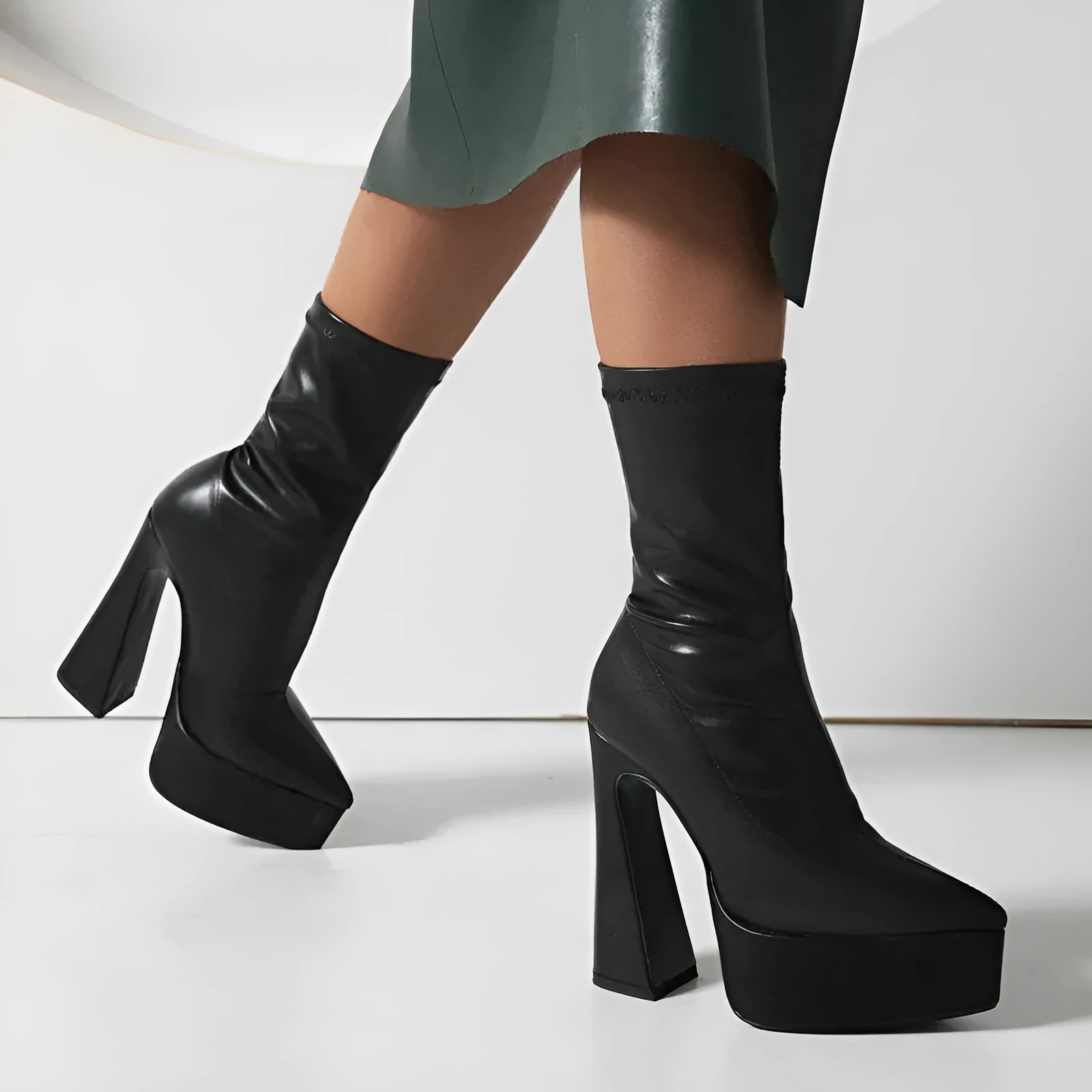 Women's black platform booties with thick super high heel and short stout heel