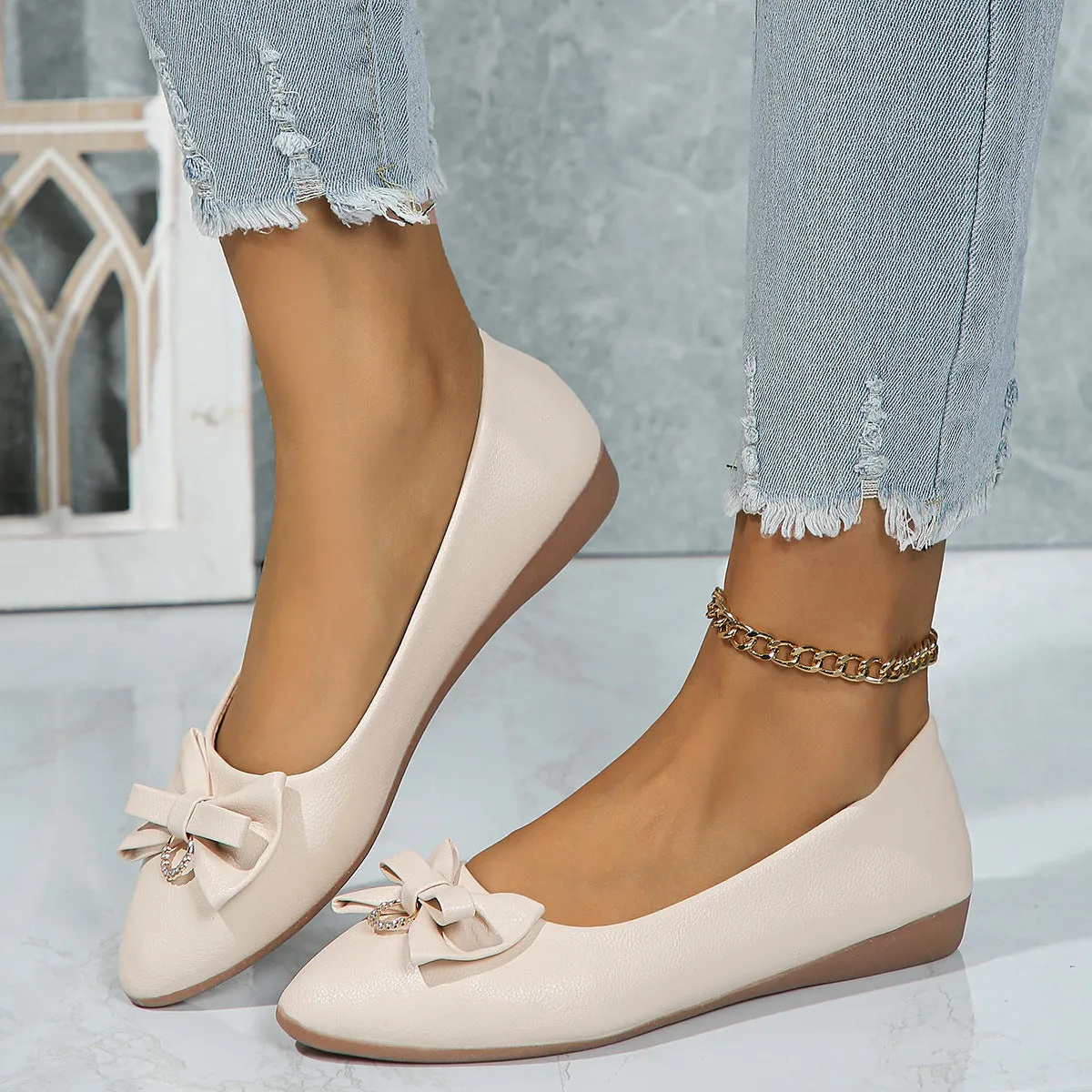 Women's beige flat casual shoes with a bowknot on the shallow mouth and a round toe.