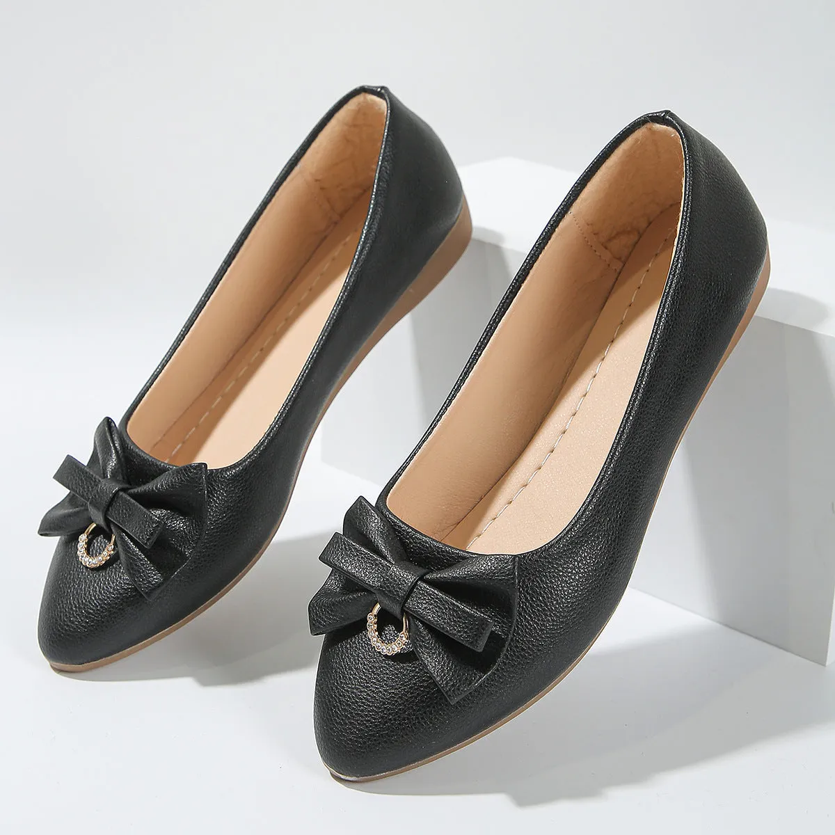 Women's beige flat casual shoes with a bowknot on the shallow mouth and a round toe.