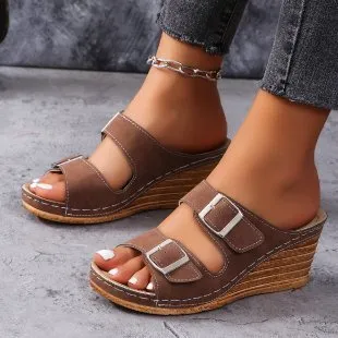 Women's creamy-white beach slippers with a wedge heel and decorative belt buckle on the upper.