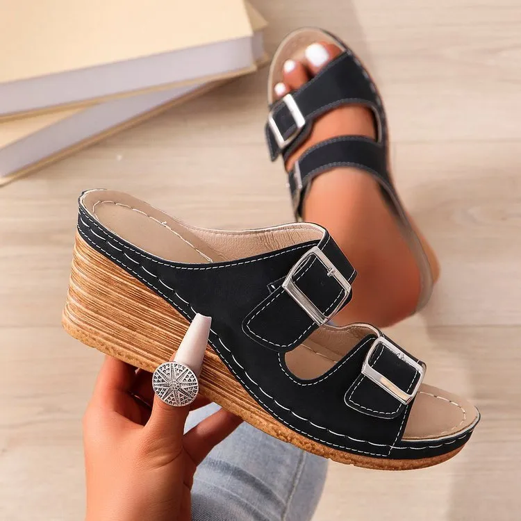 Women's creamy-white beach slippers with a wedge heel and decorative belt buckle on the upper.