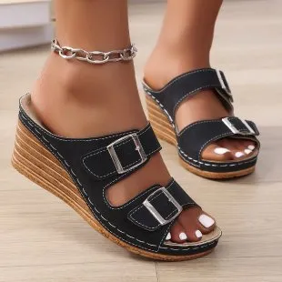 Women's creamy-white beach slippers with a wedge heel and decorative belt buckle on the upper.