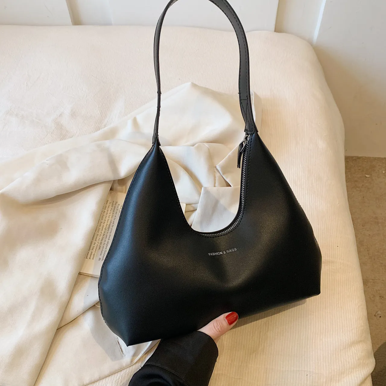 PU leather retro shoulder handbag in pillow shape with stitching details and single strap