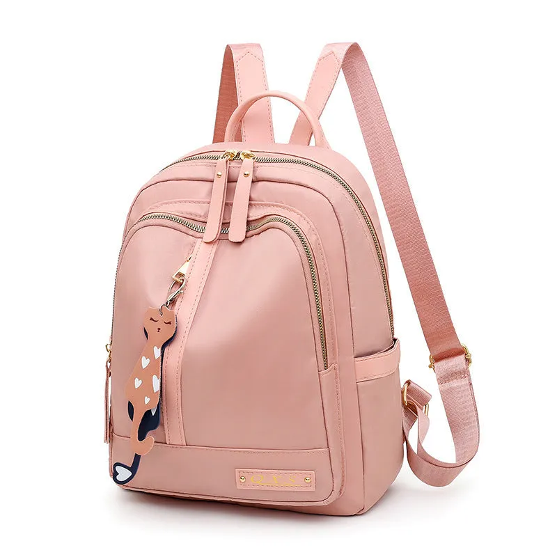 Black and pink casual nylon backpack with double straps, soft handle, and external pocket.
