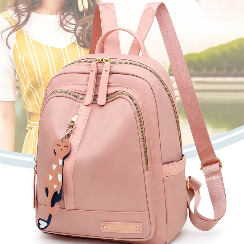 Black and pink casual nylon backpack with double straps, soft handle, and external pocket.