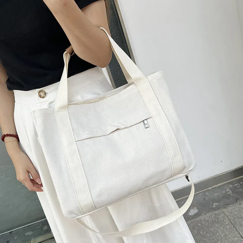 Canvas tote bag with multiple internal pockets including computer pocket, shown in horizontal square shape