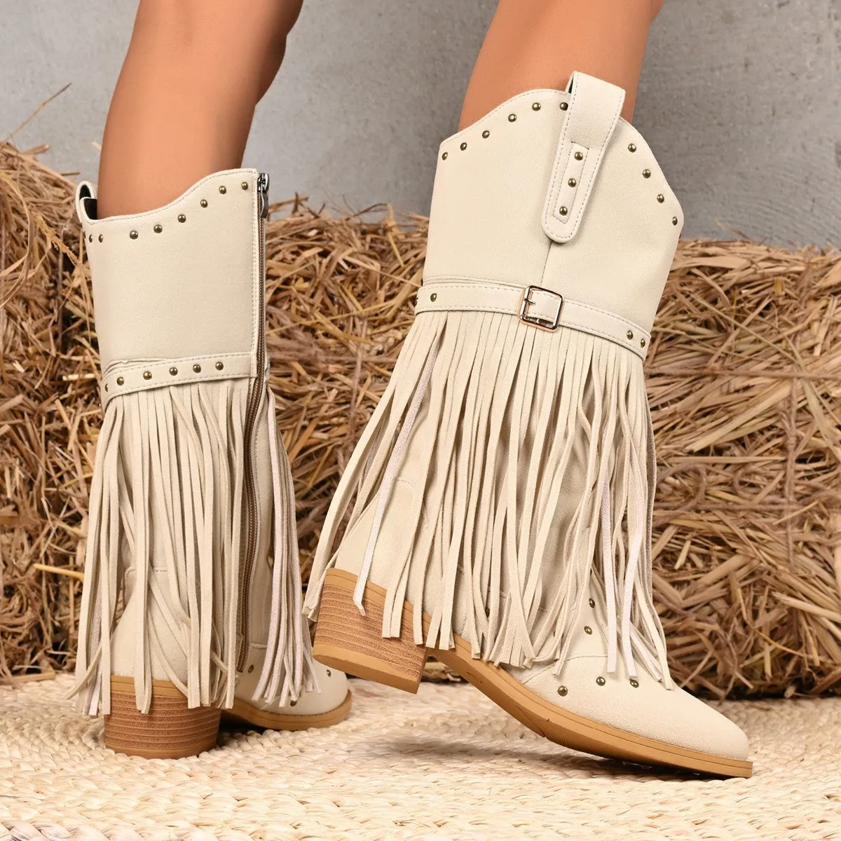 Beige women's western cowboy boots with mid heel, side zipper, and tassel details on a white background