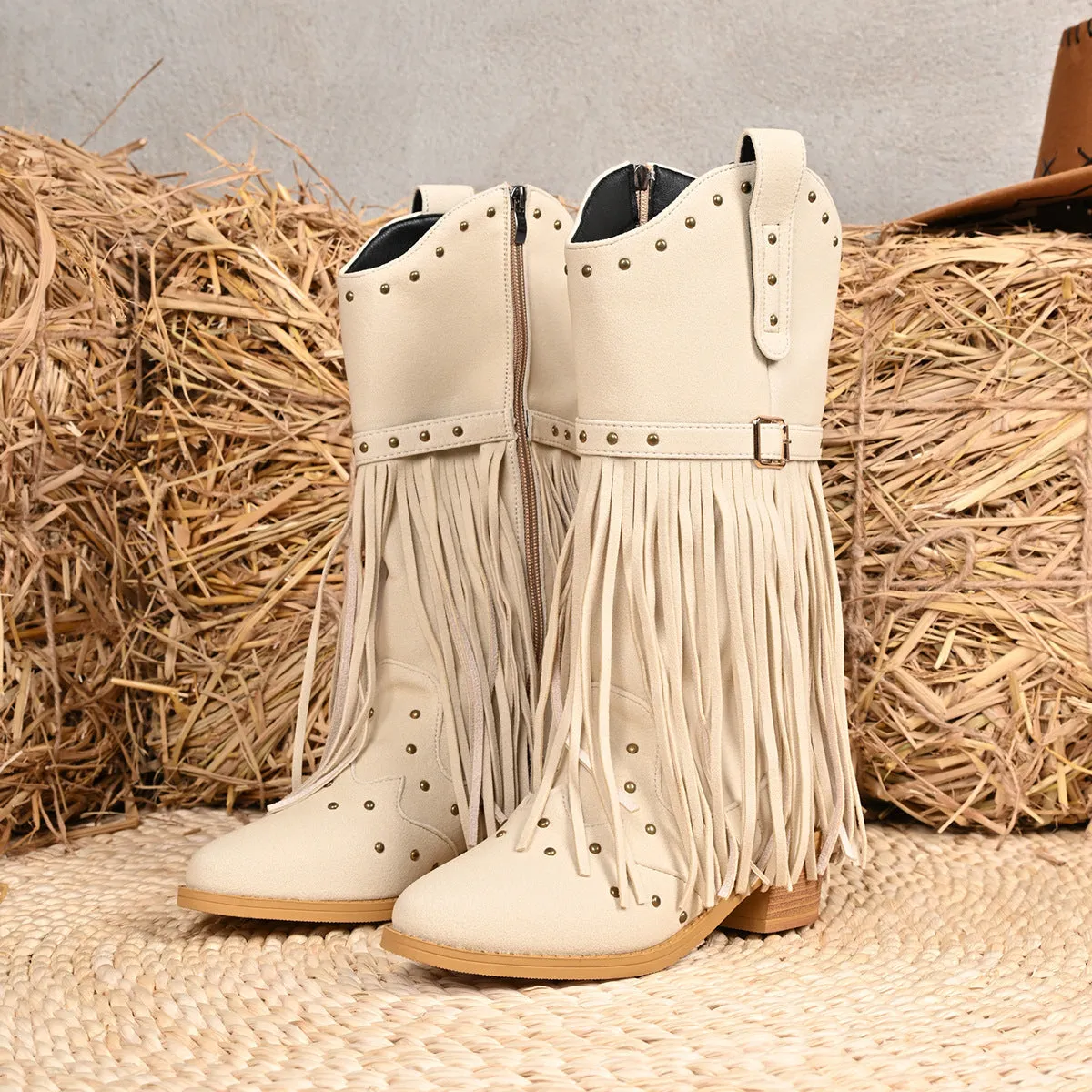 Beige women's western cowboy boots with mid heel, side zipper, and tassel details on a white background