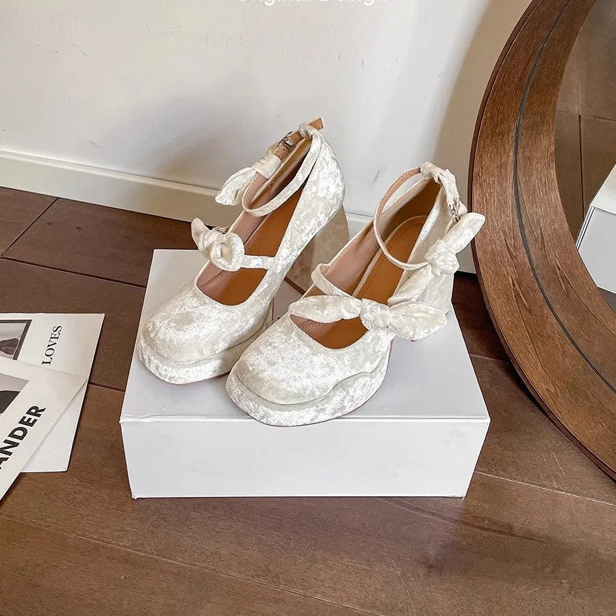 Apricot chunky heel waterproof platform pumps with bow detail, square toe, and buckle fastening on a plain background