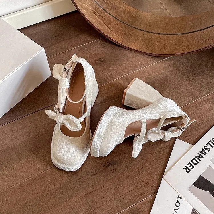 Apricot chunky heel waterproof platform pumps with bow detail, square toe, and buckle fastening on a plain background