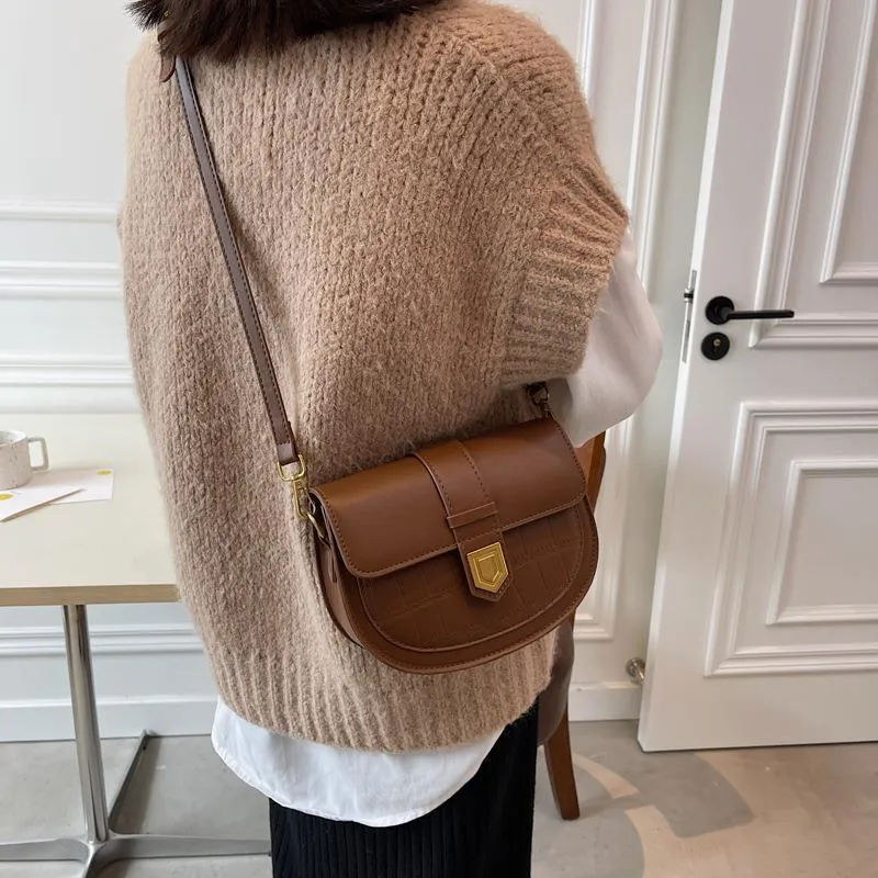 French one shoulder saddle bag in medium-soft PU with lock and stone pattern, available in black, brown, beige, and coffee