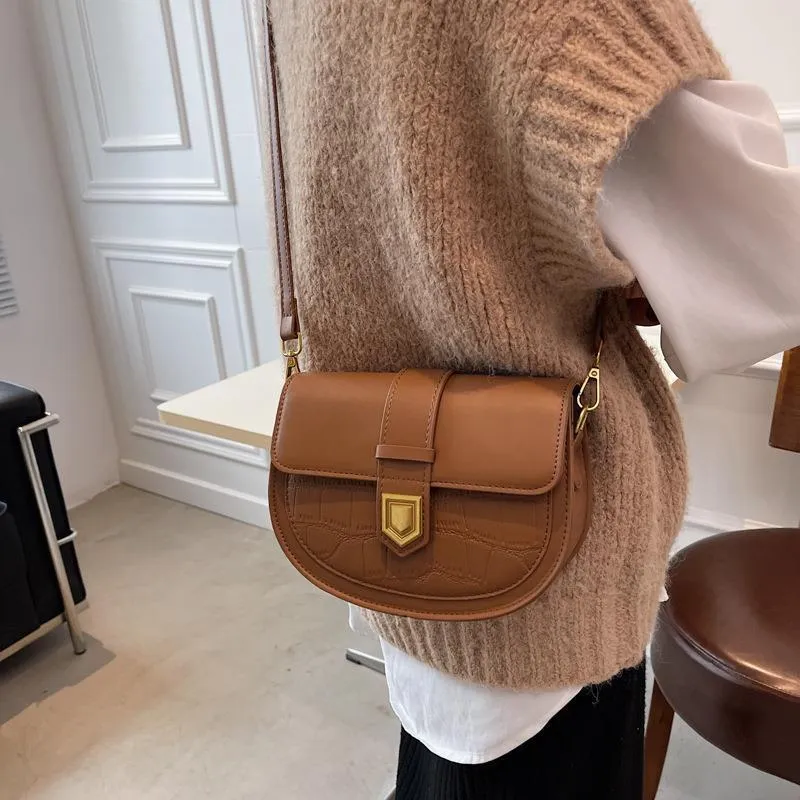French one shoulder saddle bag in medium-soft PU with lock and stone pattern, available in black, brown, beige, and coffee