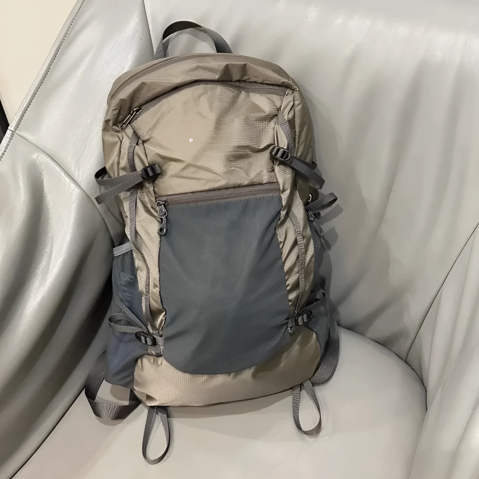 Natural revival khaki light solid colour nylon backpack with contrast details and curved shoulder straps