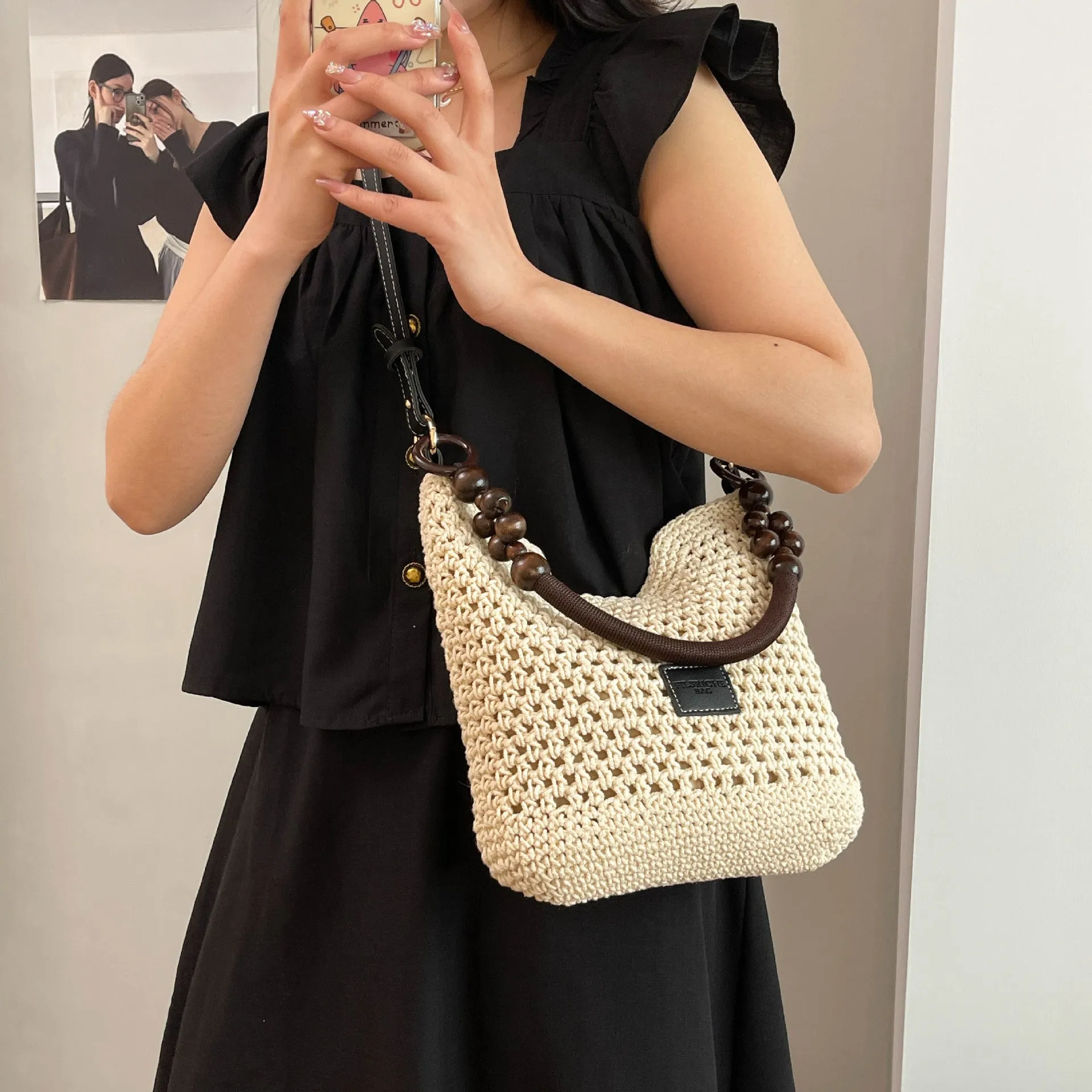 Knitted bucket tote beach bag in black or brown with contrast stitching and crossbody strap