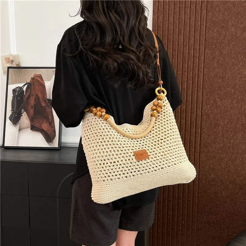 Knitted bucket tote beach bag in black or brown with contrast stitching and crossbody strap