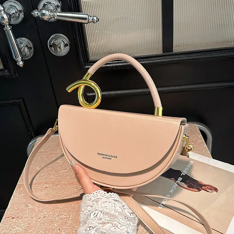 Medium hard PU box saddle bag in solid colour with internal zipper pocket and oval shape