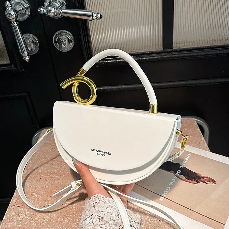 Medium hard PU box saddle bag in solid colour with internal zipper pocket and oval shape