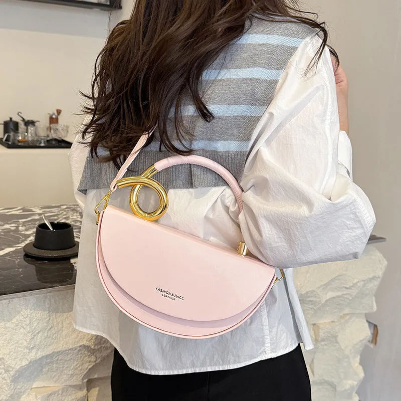Medium hard PU box saddle bag in solid colour with internal zipper pocket and oval shape
