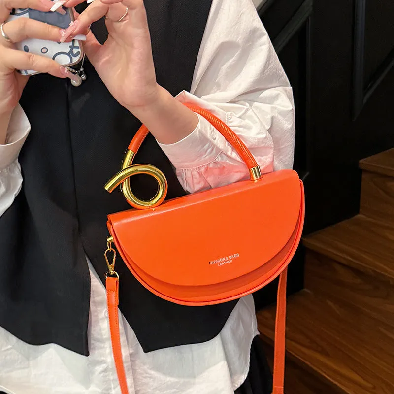 Medium hard PU box saddle bag in solid colour with internal zipper pocket and oval shape