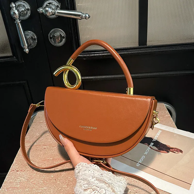 Medium hard PU box saddle bag in solid colour with internal zipper pocket and oval shape