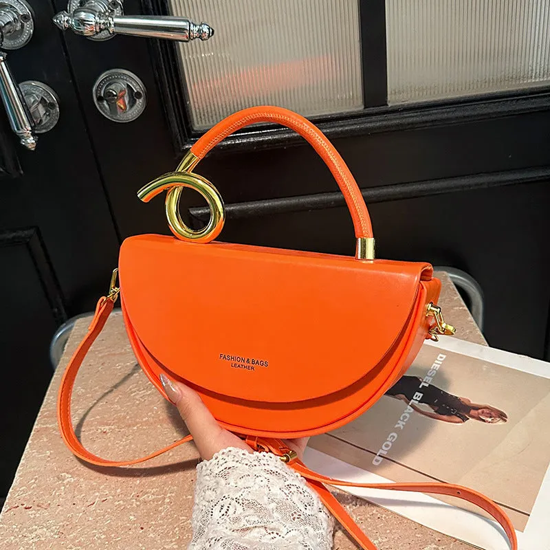 Medium hard PU box saddle bag in solid colour with internal zipper pocket and oval shape