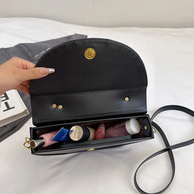 Medium hard PU box saddle bag in solid colour with internal zipper pocket and oval shape