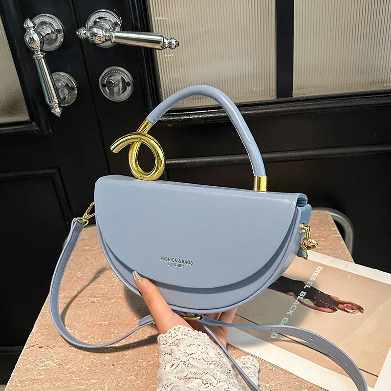 Medium hard PU box saddle bag in solid colour with internal zipper pocket and oval shape