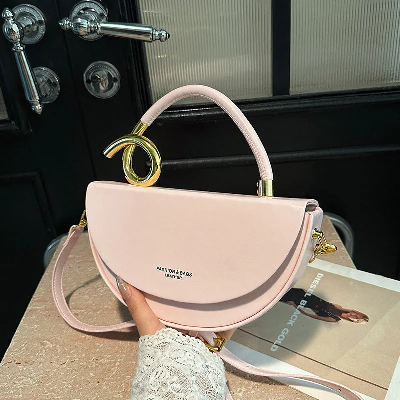 Medium hard PU box saddle bag in solid colour with internal zipper pocket and oval shape