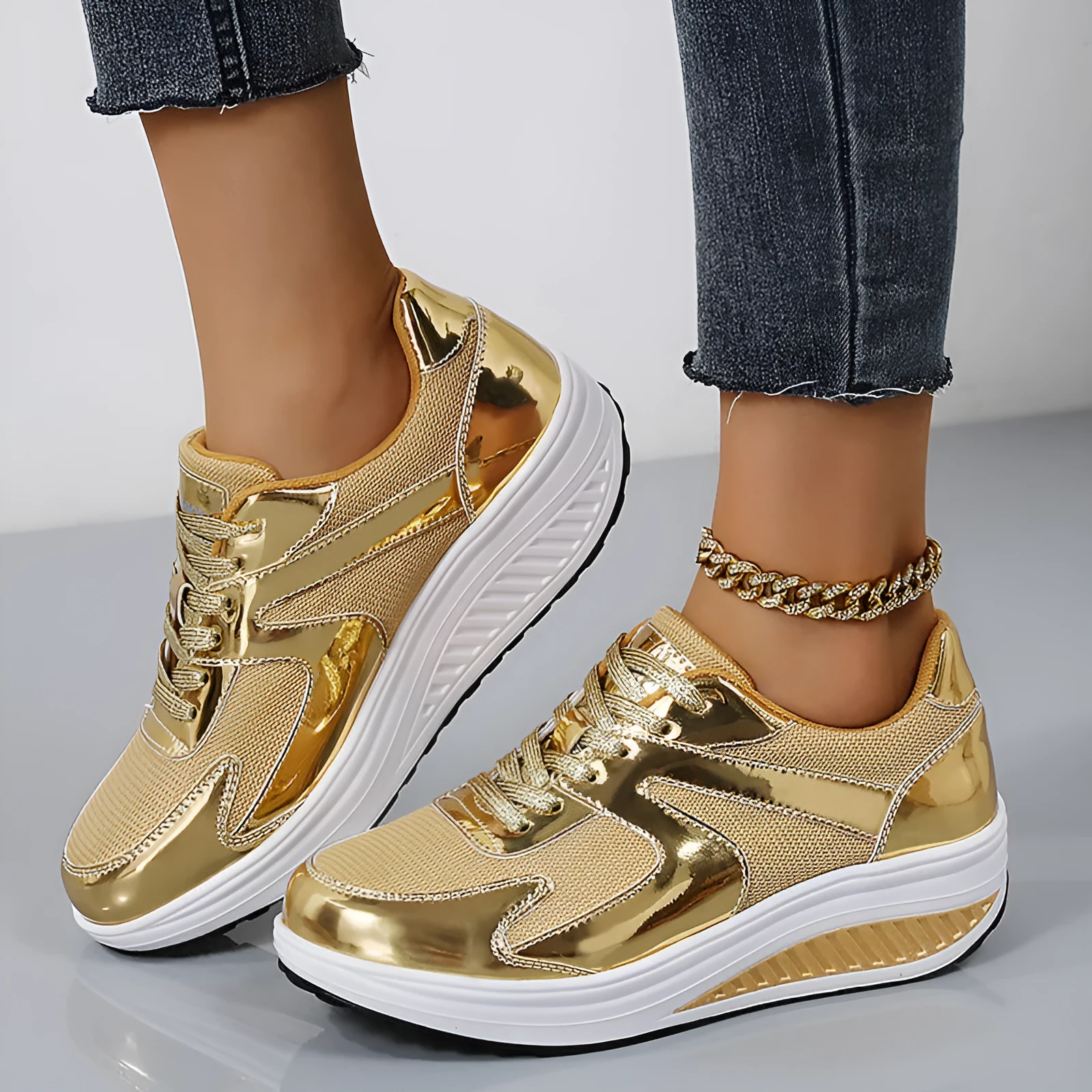 Women's gold platform trainers with mesh upper, cross-strap design and waterproof platform