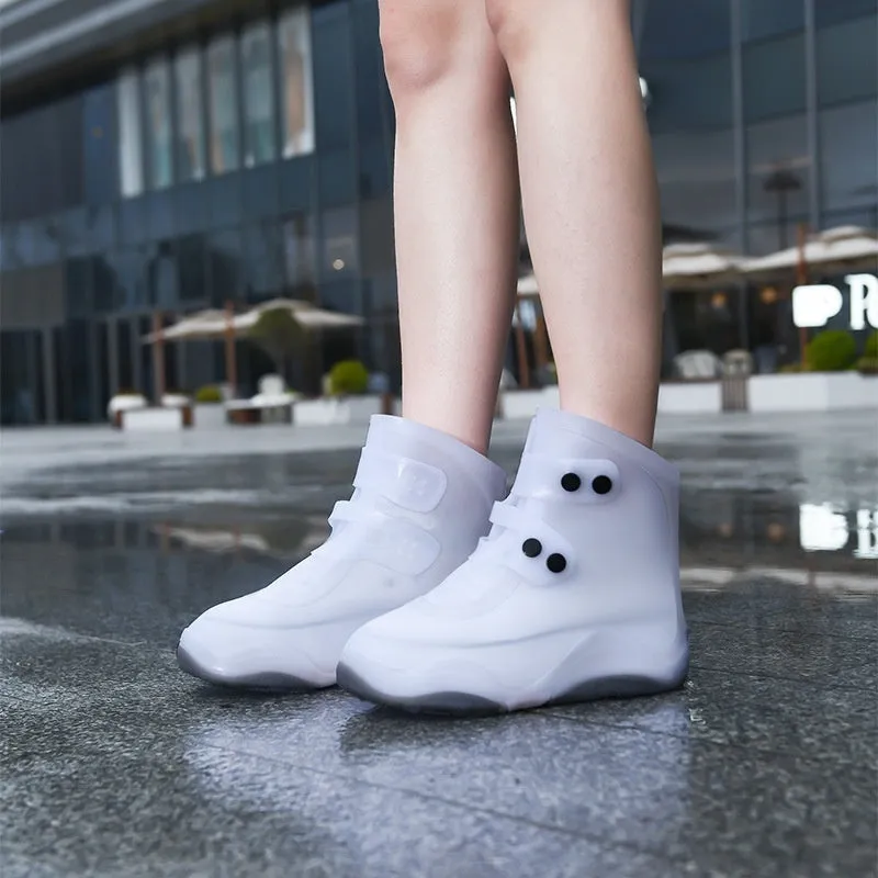 Set of waterproof silicone shoe covers in black, blue, orange, and white with non-slip soles