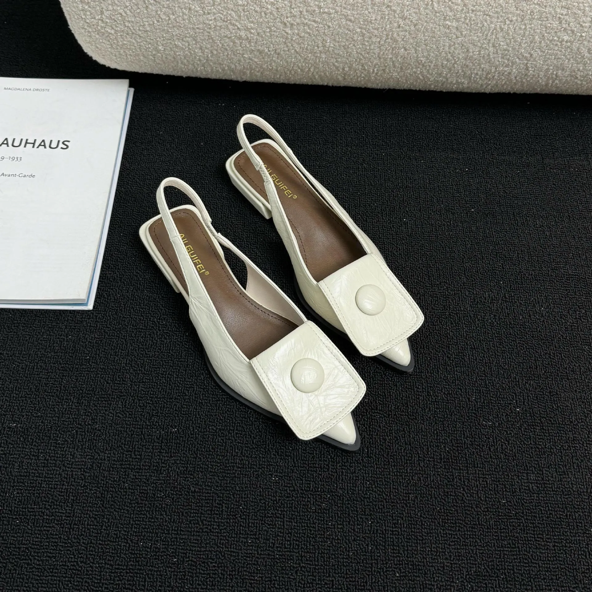 Women's low-heel closed toe sandals with a pointed toe and a back strap in apricot colour.