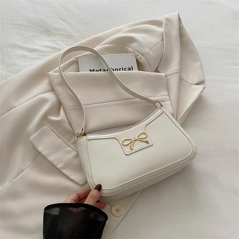 Western style PU leather shoulder bag in horizontal square shape with bow decoration, shown in rose pink colour.