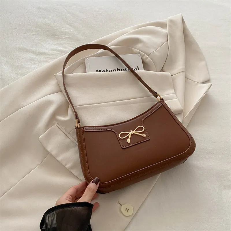 Western style PU leather shoulder bag in horizontal square shape with bow decoration, shown in rose pink colour.