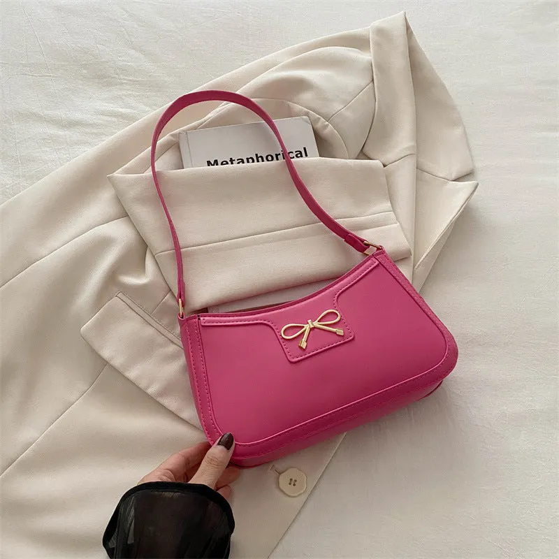 Western style PU leather shoulder bag in horizontal square shape with bow decoration, shown in rose pink colour.