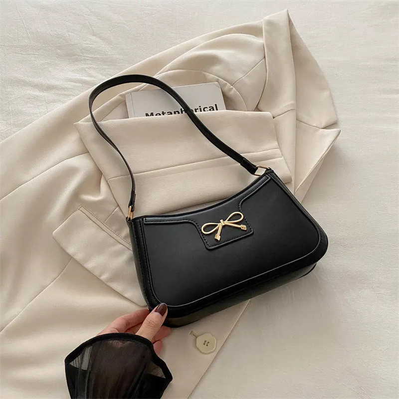 Western style PU leather shoulder bag in horizontal square shape with bow decoration, shown in rose pink colour.