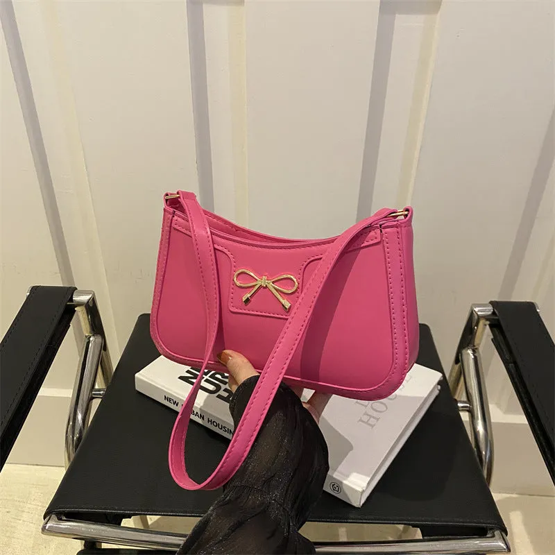 Western style PU leather shoulder bag in horizontal square shape with bow decoration, shown in rose pink colour.