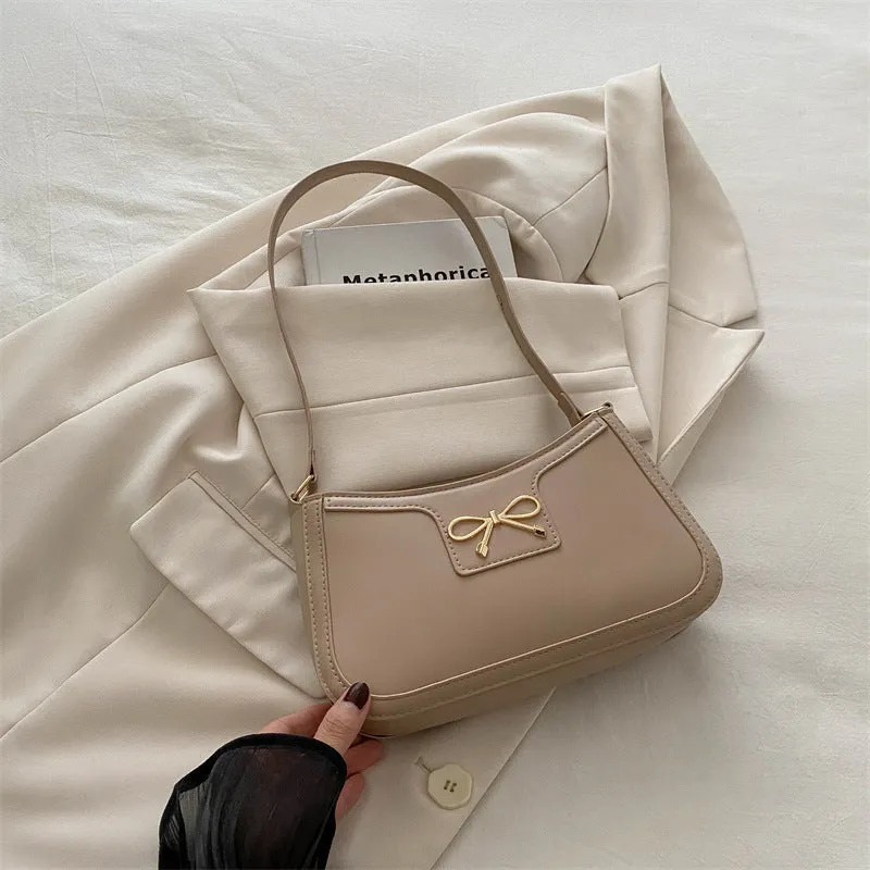 Western style PU leather shoulder bag in horizontal square shape with bow decoration, shown in rose pink colour.