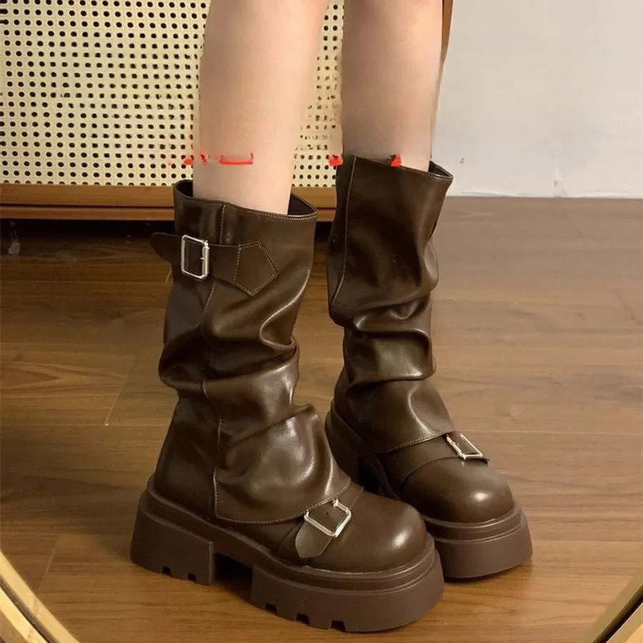 Brown retro platform boots with wedge heel, side zipper, round toe, and belt buckle detail on a white background