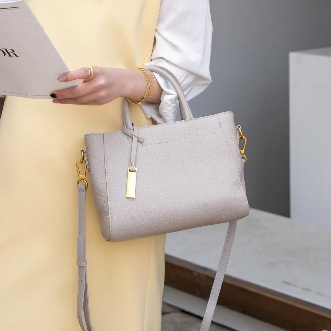 Portable genuine leather women handbag in soft cowhide with horizontal square shape and single strap, available in multiple colours