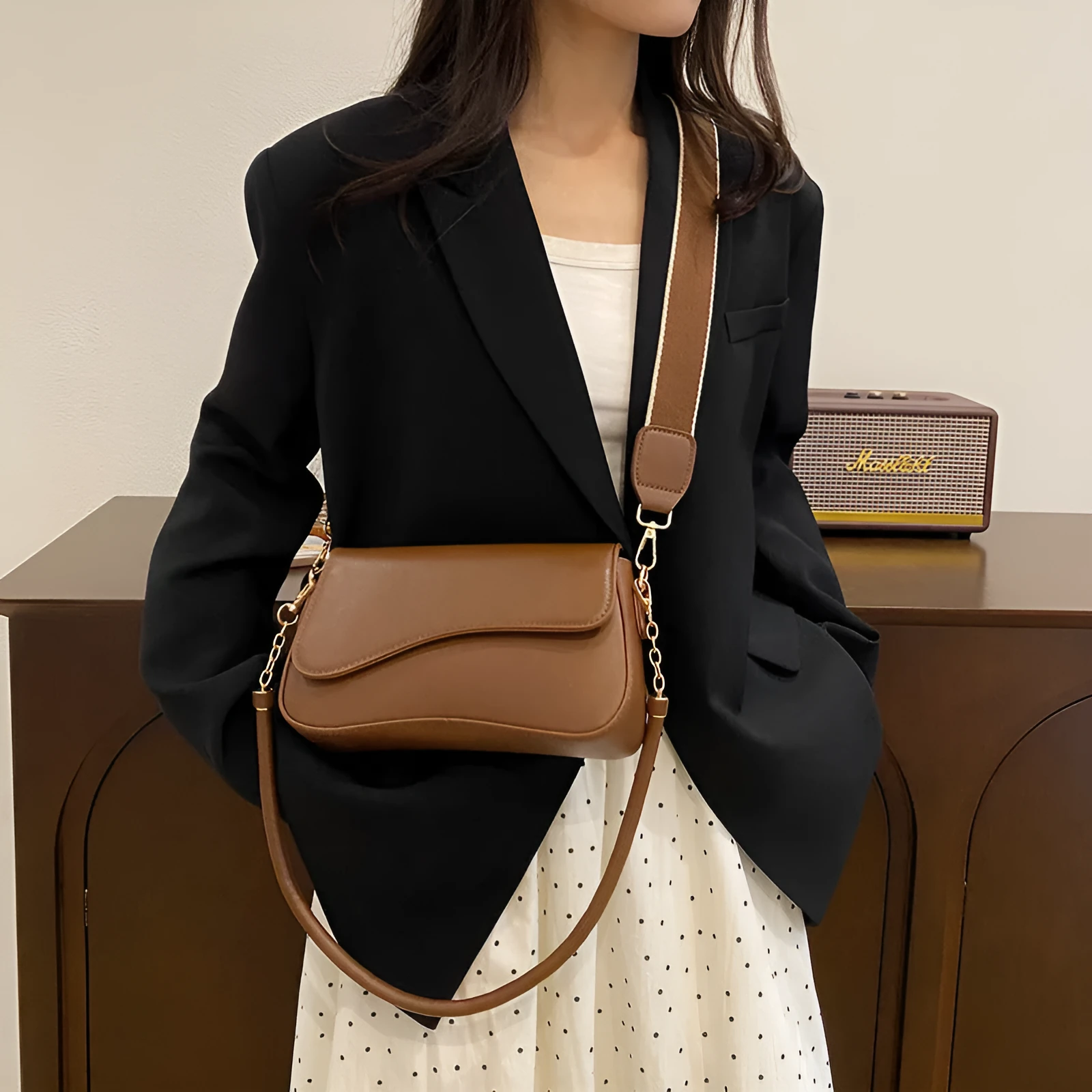 Retro women's messenger bag in black PU leather with horizontal square shape and double shoulder straps.